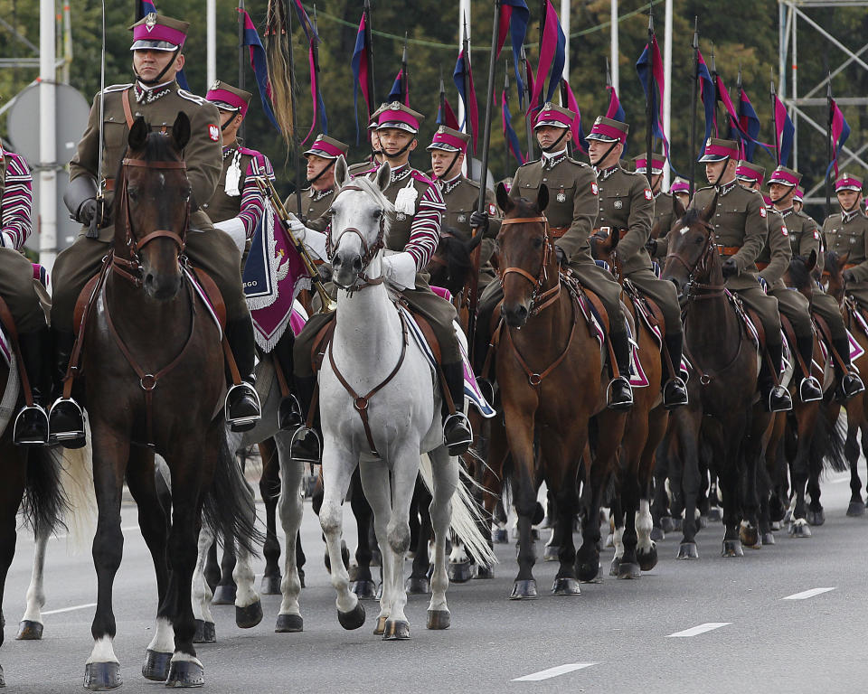 People dressed in historical military costumes during an Armed Forces Day parade in Warsaw, Poland, Wednesday, Aug. 15, 2018. Poland's President Andrzej Duda voiced in a speech, that he hopes for a permanent U.S. military presence in his country.(AP Photo/Czarek Sokolowski)