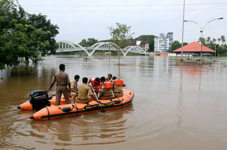 FILE PHOTO: Rescue personnel patrol flooded waters on the banks of Periyar River after the opening of Idamalayar and Cheruthoni dam gates following heavy rains, on the outskirts of Kochi, August 10, 2018. REUTERS/Sivaram V/File Photo