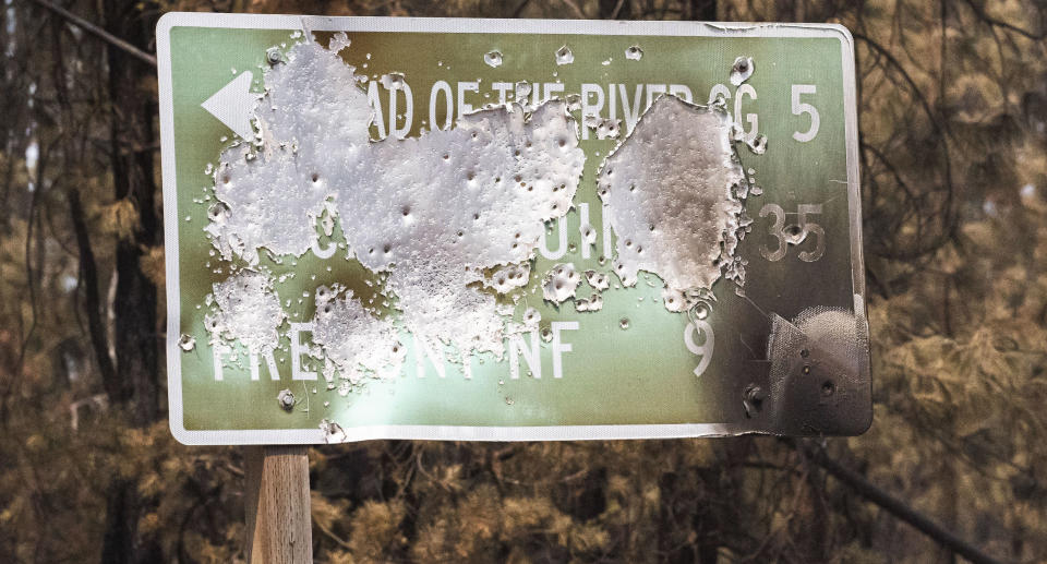 A sign damaged in one of the largest wildfires in the United States, the Bootleg fire. Source: AP