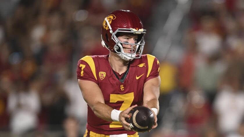 USC quarterback Miller Moss hands off the ball during a game against San José State