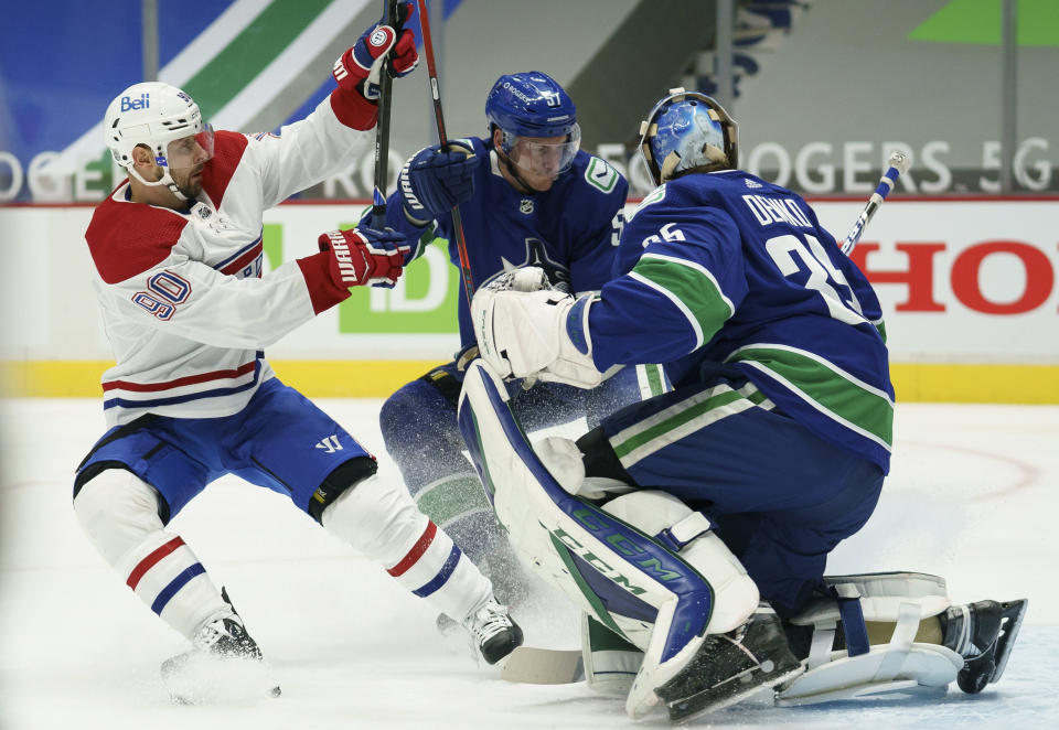 Vancouver Canucks defenseman Tyler Myers (57) stops Montreal Canadiens left wing Tomas Tatar (90) from getting a shot on Canucks goaltender Thatcher Demko (35) during the first period of an NHL hockey game Thursday, Jan. 21, 2021, in Vancouver, British Columbia. (Jonathan Hayward/The Canadian Press via AP)