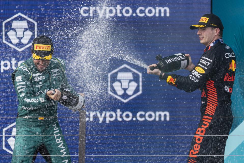 Red Bull Racing's Dutch driver Max Verstappen, who placed first, right, and Aston Martin's Spanish driver Fernando Alonso, who placed third, celebrate on the podium the Formula One Miami Grand Prix at the Miami International Autodrome on Sunday, May 7, 2023, in Miami Gardens, Fla.(Matias J. Ocner/Miami Herald via AP)
