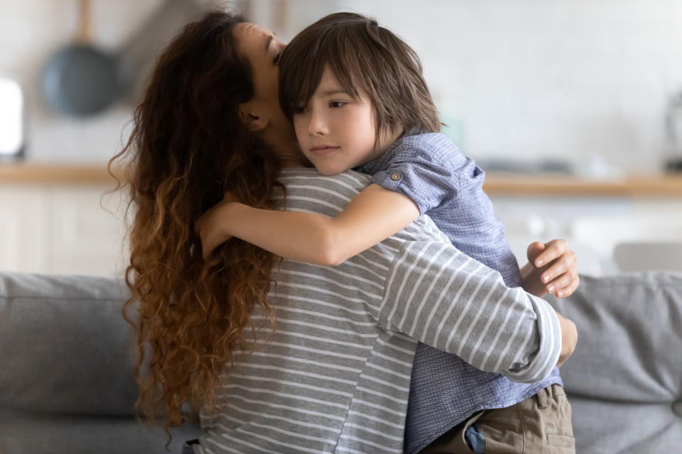 A mom gives her son a big hug