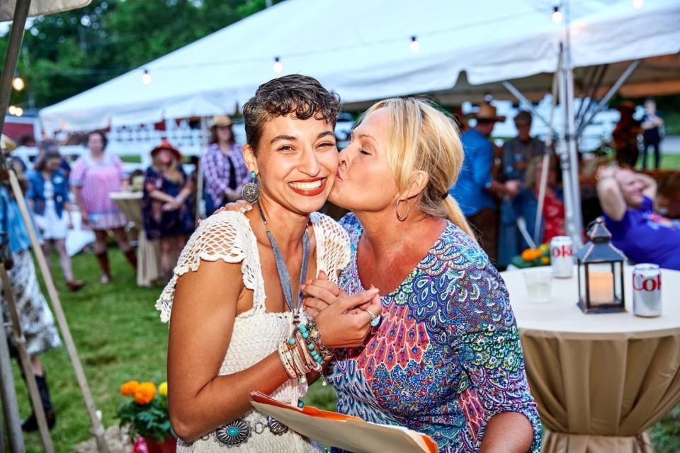 Alyssa Regan (left) gets a kiss from mother-in-law Lynn Regan at CFC Loud N’ Clear Foundation's annual gala.
(Photo: Alphonse Telymonde/@Telyphoto)