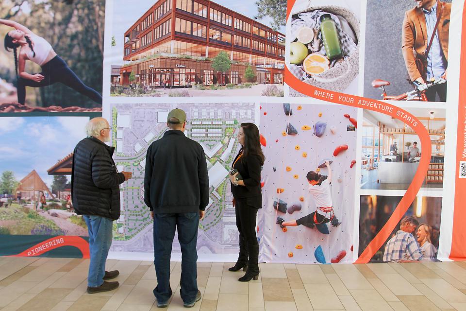 Krista Sprenger, right, executive vice president of commercial and mixed-use with McWhinney, goes over details regarding a mix-use district that will encompass miles of trails and public space to local residents during a public open house held by McWhinney and Prism Places at the Foothills Mall on Saturday, April 15, 2023.
