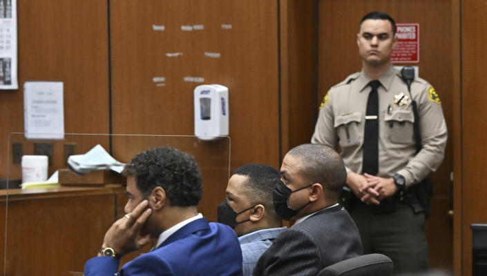Eric Holder, center, looks on, while seated beside his attorney Aaron Jensen, left, during closing arguments at his trial on Thursday, June 30, 2022, in Los Angeles over the death of Grammy-winning rapper Nipsey Hussle. (Frederic J. Brown/Pool Photo via AP)