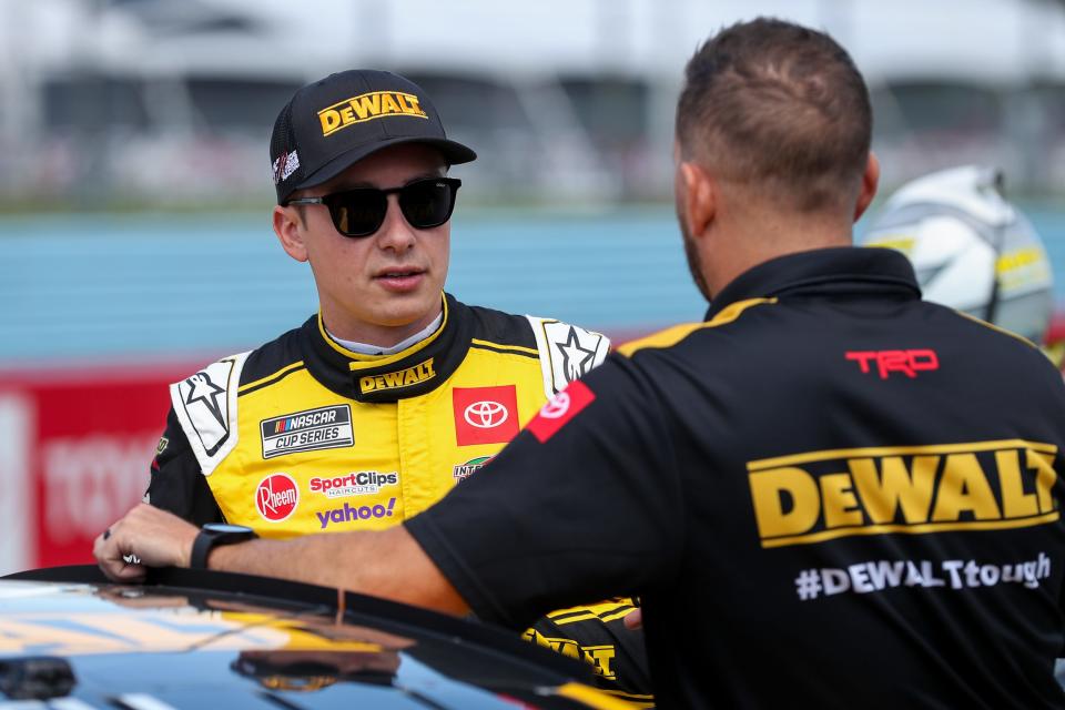 NASCAR Cup Series driver Christopher Bell (left) talks with a crew member during practice and qualifying for the Go Bowling at The Glen at Watkins Glen International on Aug. 19, 2023.