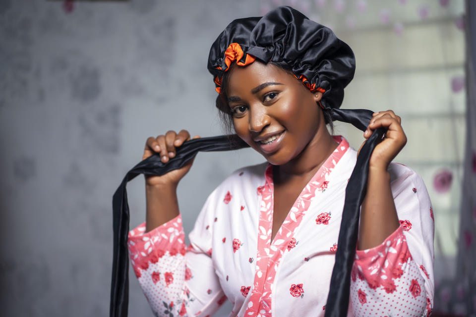 Woman in dressing gown and hair bonnet