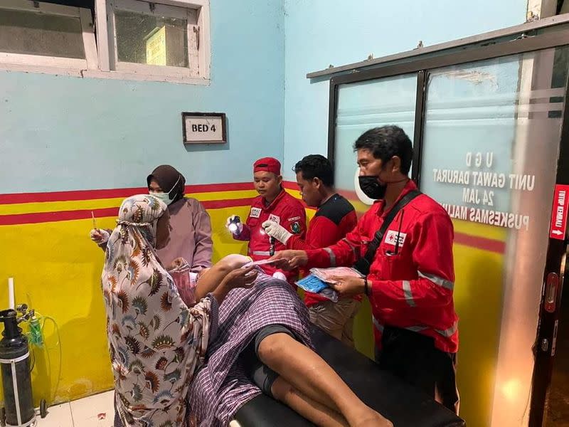 An injured person is taken care of following an earthquake in Mamuju