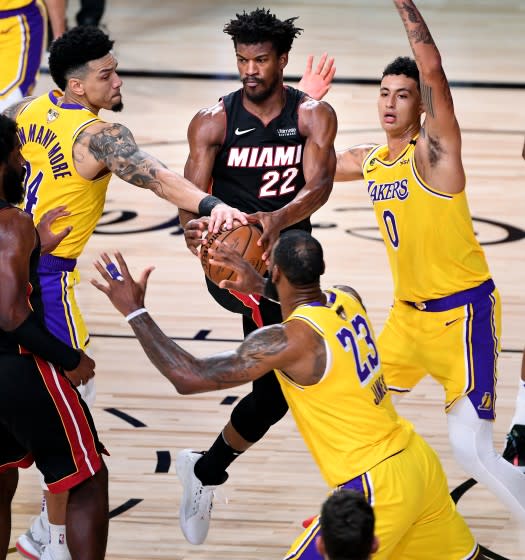 Lakers guard Danny Green, left, knocks the ball from Heat forward Jimmy Butler during Game 1.