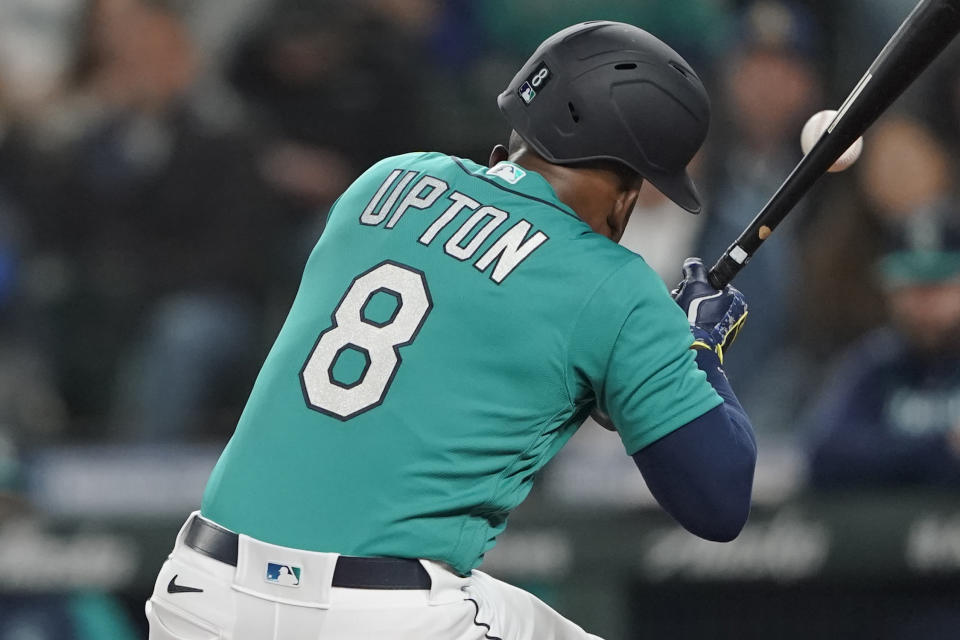Seattle Mariners' Justin Upton is hit by a pitch during the fifth inning of a baseball game against the Los Angeles Angels, Friday, June 17, 2022, in Seattle. Upton left the game after the injury. (AP Photo/Ted S. Warren)