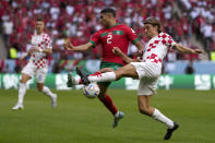 Morocco's Achraf Hakimi and Croatia's Borna Sosa , right, challenge for the ball during the World Cup group F soccer match between Morocco and Croatia, at the Al Bayt Stadium in Al Khor , Qatar, Wednesday, Nov. 23, 2022. (AP Photo/Manu Fernandez)