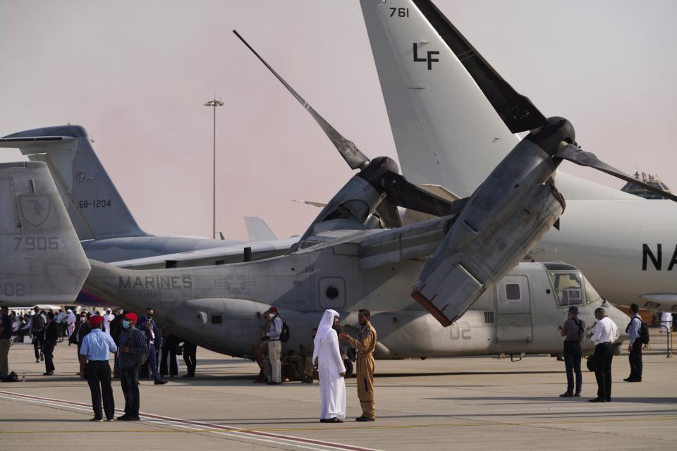 People gather in front of a U.S. Marine Corps Bell Boeing V-22 Osprey at the Dubai Air Show in Dubai, United Arab Emirates, Wednesday, Nov. 17, 2021. (AP Photo/Jon Gambrell)