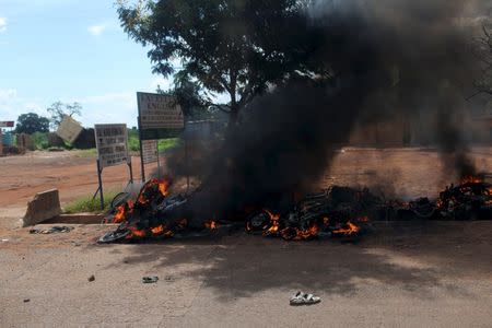 Motorcycles are seen burning on a street in Ouagadougou, Burkina Faso September 20, 2015. REUTERS/Joe Penney