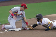 St. Louis Cardinals third baseman Tommy Edman, left, drops the ball as San Diego Padres' Tommy Pham advances to third during the sixth inning of Game 1 of a National League wild-card baseball series Wednesday, Sept. 30, 2020, in San Diego. Edman was charged with an error. (AP Photo/Gregory Bull)