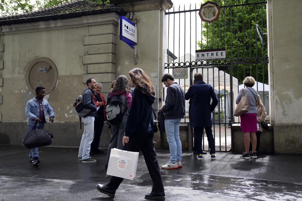 People queue outside a police station to fill out forms to vote by proxy, prior to the upcoming parliamentary elections in Paris, Wednesday, June 8, 2022. The legislative elections will take place on June 12 and 19, 2022. (AP Photo/Francois Mori)