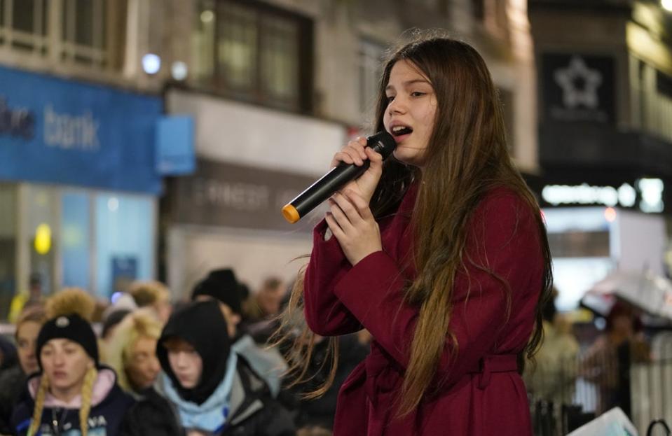 12-year-old Astrid Smith sings during the vigil (Danny LAwson/PA) (PA Wire)