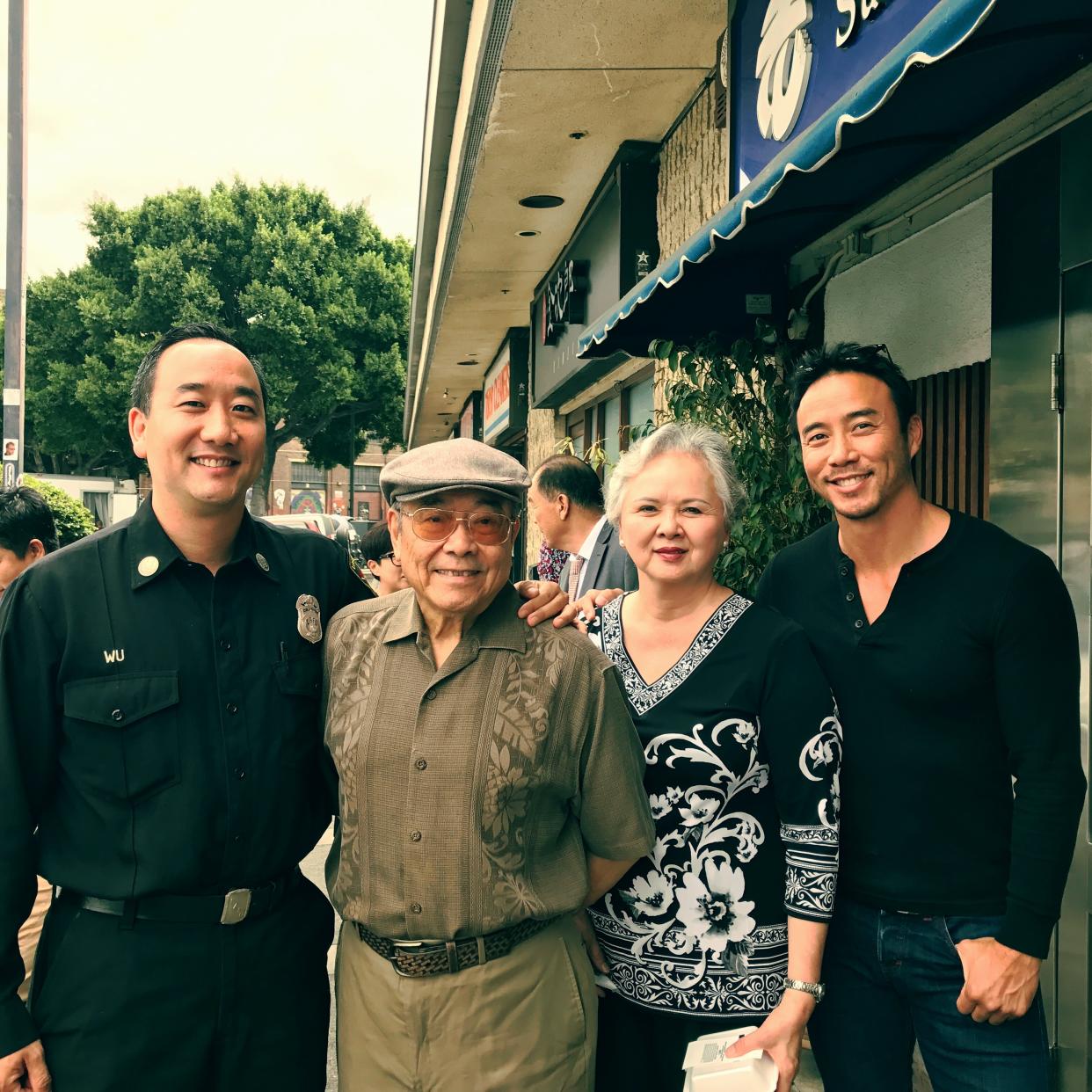 Allan Wu pictured with his dad (second from left)