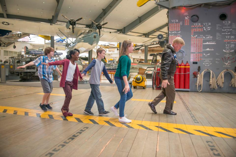 Kids walking the Cabot deck at the National Naval Aviation Museum.