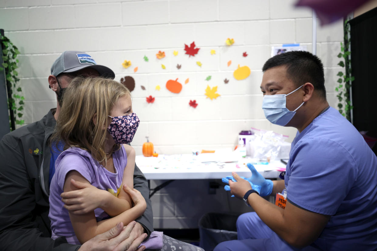 Lilah Chipman talks with Dominic Dinh before he administers a pediatric Pfizer COVID-19 vaccination during a vaccination clinic on November 03, 2021 in San Jose, California. (Photo by Justin Sullivan/Getty Images)