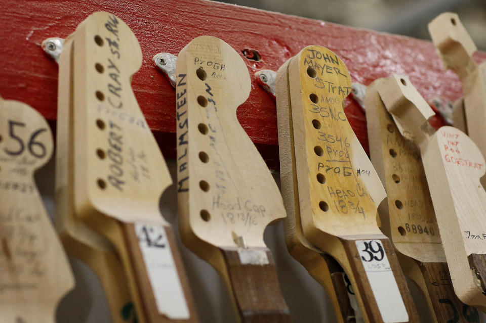 The Fender Stratocaste neck templates of iconic guitarists Robert Cray, Yngwie Malmsteen and John Mayer hang in the Fender factory in Corona, Calif. on Monday, Oct. 14, 2013. The Fender Stratocaster, used by countless professional and amateur musicians, celebrates its 60th anniversary in 2014. (AP Photo/Matt York)