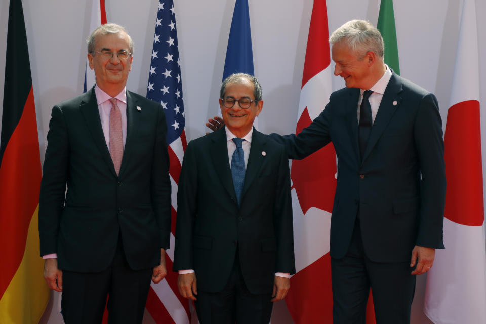 French Finance Minister Bruno Le Maire, right, welcomes Italian Economy and Finance Minister Giovanni Tria , center, with Governor of the Bank of France Francois Villeroy de Galhau, at the G-7 Finance Wednesday July 17, 2019.The top finance officials of the Group of Seven rich democracies are arriving at Chantilly, at the start of a two-day meeting aimed at finding common ground on how to tax technology companies and on the risk from new digital currencies. (AP Photo/Michel Euler)