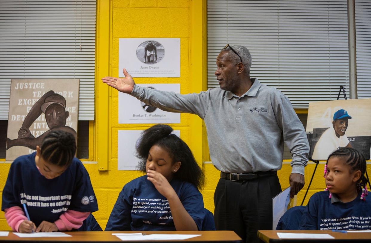 Brooklyn Johnson, left, Samya Jacks, and Morgan McDonald listen to Sam Abrams, standing, founder of The Davas Foundation, teach a Nine Values of an American Legend lesson inside the Tindal Activity Center in Detroit on Wednesday, April 10, 2024.