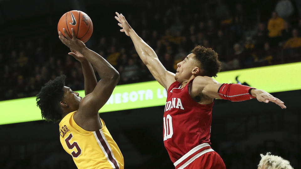 Minnesota's Marcus Carr shoots as Indiana's Rob Phinisee defends during the first half of an NCAA college basketball game Wednesday, Feb. 19, 2020, in Minneapolis. (AP Photo/Stacy Bengs)