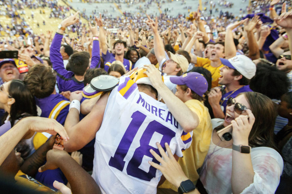 LSU’s Foster Moreau (18) is surrounded as fans rush the field after the Tigers 36-16 win over Georgia in an NCAA college football in Baton Rouge, La., Saturday, Oct. 13, 2018. (AP Photo/Matthew Hinton)