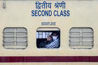 A migrant worker waves from the window of a special train going to Gorakhpur in Uttar Pradesh state back to his hometown after the government eased a nationwide lockdown imposed as a preventive measure against the COVID-19 coronavirus, in Amritsar on May 14, 2020. (Photo by NARINDER NANU / AFP) (Photo by NARINDER NANU/AFP via Getty Images)