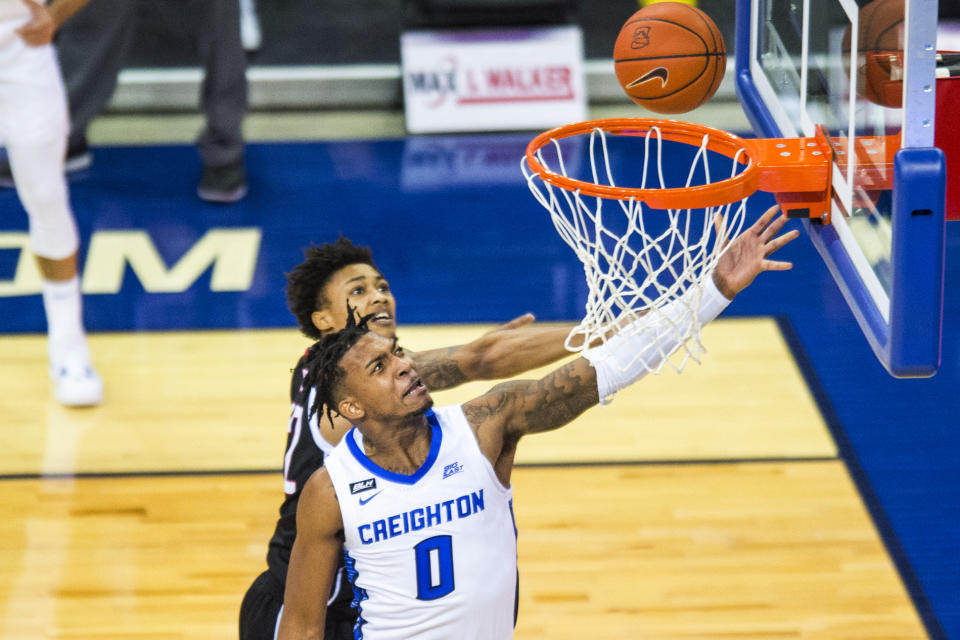 Creighton's Antwann Jones scores against Omaha's Marco Smith Jr. during the first half of an NCAA college basketball game in Omaha, Neb., Tuesday, Dec. 1, 2020. (AP Photo/Kayla Wolf)