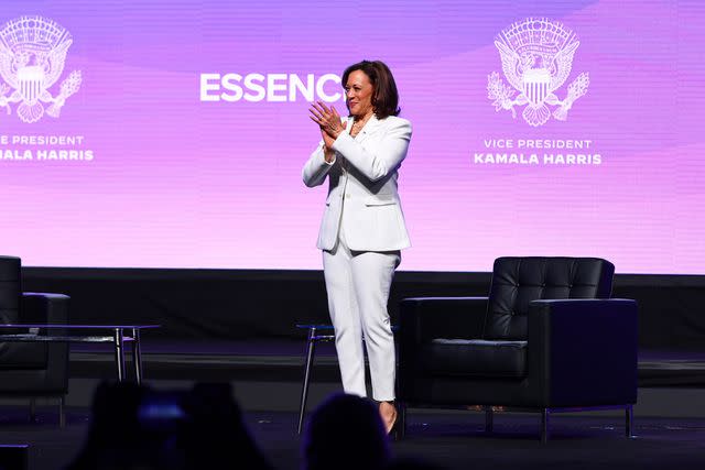 <p>Arturo Holmes/Getty</p> Vice President Kama Harris wears a white suit to the 2023 Essence Festival of Culture.