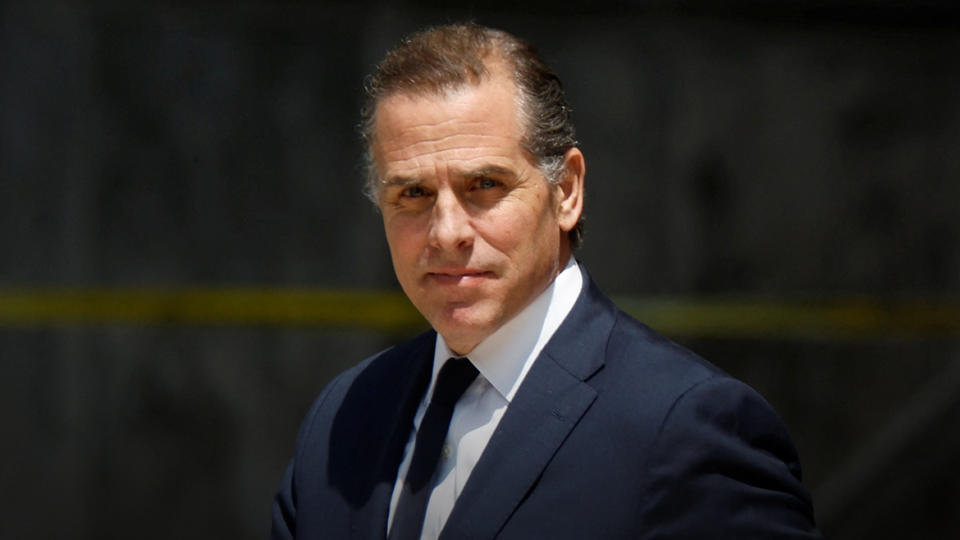 Hunter Biden, wearing a dark suit and tie, leaves federal court. 