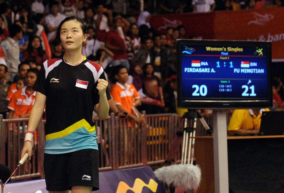 Fu Mingtian of Singapore gestures as she plays against Firdasari Adryanti of Indonesia during the badminton individual final at the 26th Southeast Asian Games (SEAGAMES) in Jakarta on November 19, 2011. Fu won the match to take home the gold medal. AFP PHOTO / ADEK BERRY (Photo credit should read ADEK BERRY/AFP via Getty Images)