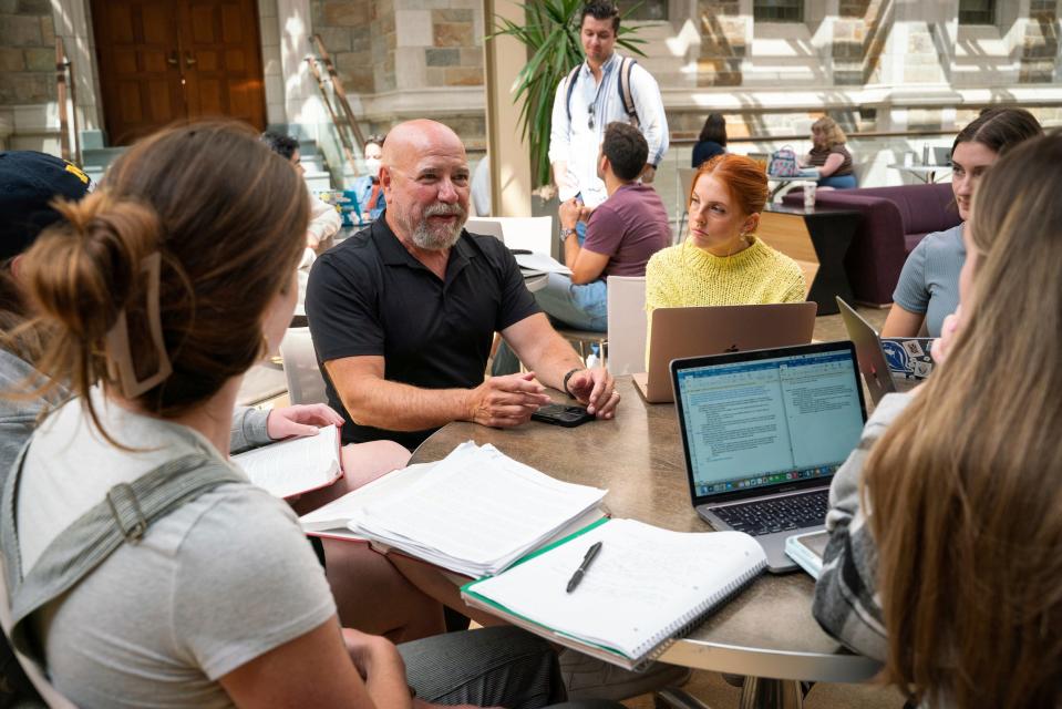Len Niehoff, 65, a professor at the University of Michigan Law School, left, talks with Heather Foster, 24, right, and other students from his civil procedures class at Hutchins Hall in Ann Arbor on Wednesday, August 30, 2023.