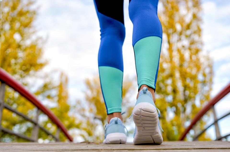 rear view of the feet of a woman runner in sneakers