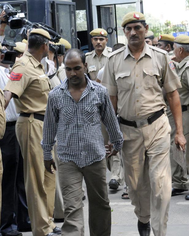 Indian police escort Mukesh Singh -- one of four men condemned to death for the murder and gang-rape of an student in new Delhi -- after his 2013 trial at the High Court in New Delhi