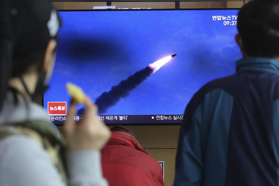 People watches a televsion screen showing a file image of North Korea's missile launch during a news program at the Seoul Railway Station in Seoul, South Korea, Saturday, March 21, 2020. North Korea on Saturday fired two presumed short-range ballistic missiles into the sea, South Korea's military said, as it continues to expand military capabilities amid deadlocked nuclear negotiations with the Trump administration and a crippling global health crisis. (AP Photo/Ahn Young-joon)