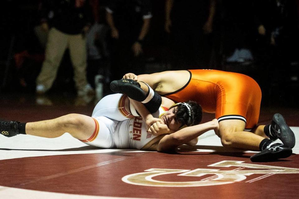 Golden Valley’s Raymond Miller wrestles Merced’s Anthony Nixon during a match at Golden Valley High School in Merced, Calif., on Tuesday, Jan. 23, 2024.