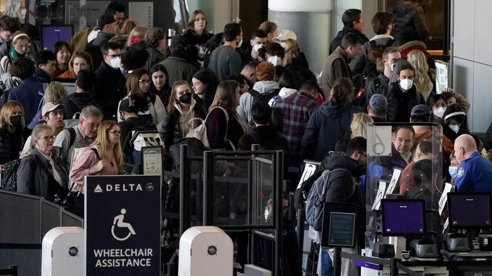 Travelers stand in line at a security checkpoint before boarding flights the day before Thanksgiving, Wednesday, Nov. 23, 2022, at Logan International Airport in Boston. [Steven Senne/AP, file]