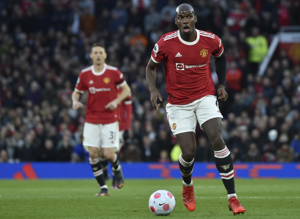 FILE - Manchester United's Paul Pogba controls the ball during the English Premier League soccer match between Manchester United and Tottenham Hotspur, at the Old Trafford stadium in Manchester, England, on March 12, 2022. Pogba will miss the World Cup with ongoing knee problems. (AP Photo/Rui Vieira, File)