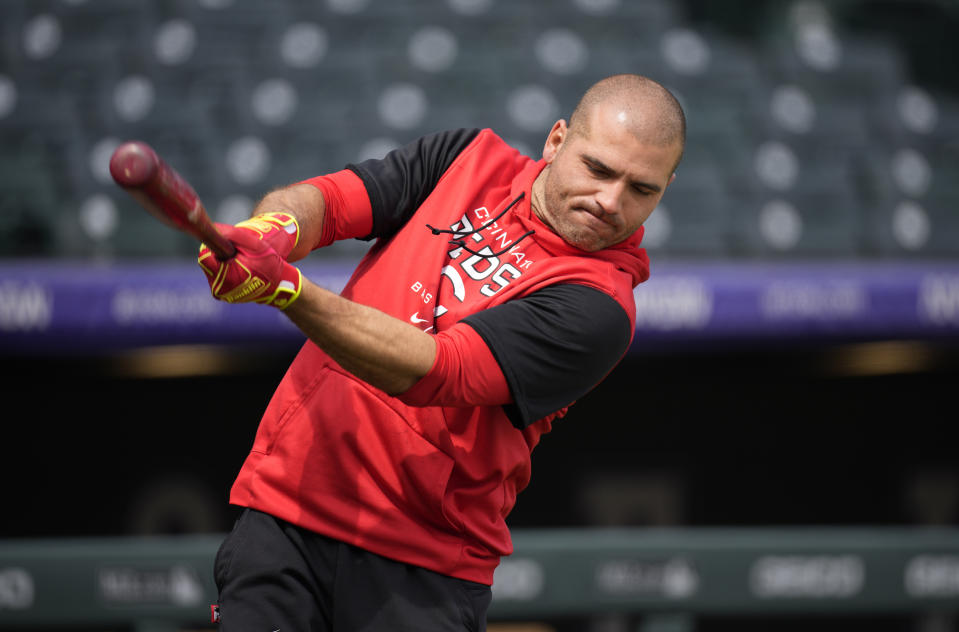 Cincinnati Reds' Joey Votto warms up before a baseball game against the Colorado Rockies, Sunday, May 1, 2022, in Denver. (AP Photo/David Zalubowski)