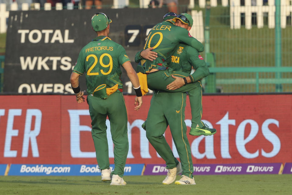 South Africa's Aiden Markram, right, is congratulated by teammate's David Miller and Dwaine Pretorius, left, after taking a catch to dismiss Australia's Steven Smith during the Cricket Twenty20 World Cup match between South Africa and Australia in Abu Dhabi, UAE, Saturday, Oct. 23, 2021. (AP Photo/Kamran Jebreili)