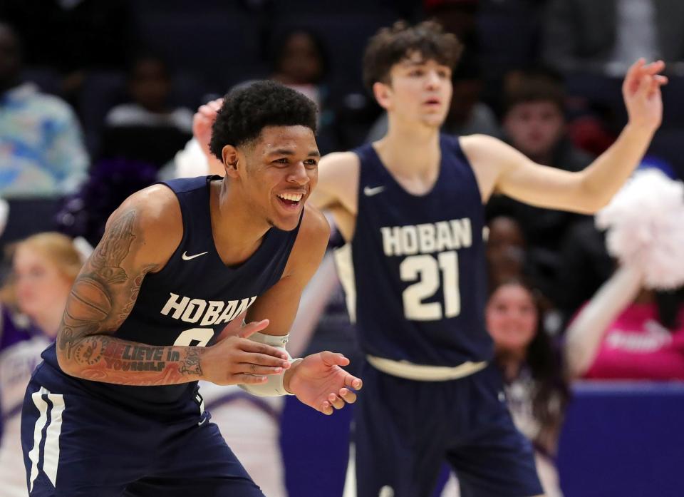 Hoban guard Jonas Nichols, left, celebrates as the Knights increase their lead over Pickerington Central during the second half of the OHSAA Division I state championship game, Sunday, March 19, 2023, in Dayton.