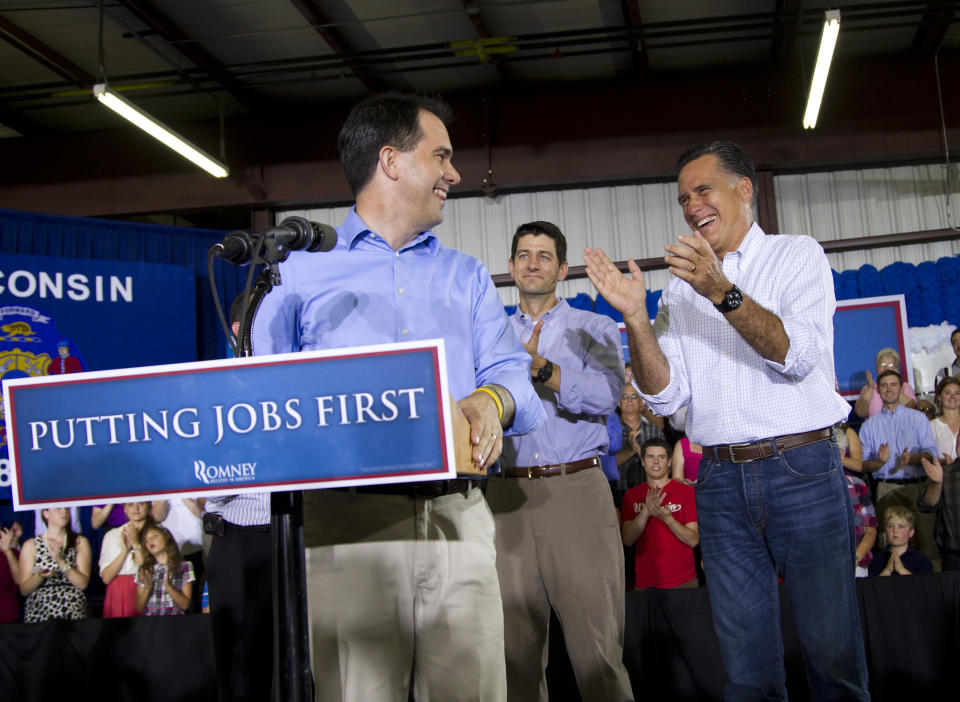 Republican presidential candidate, former Massachusetts Gov. Mitt Romney, right, is introduced by Gov. Scott Walker, R-Wis., left, as Rep. Paul Ryan, R- Wis. looks on during a campaign stop at Monterey Mills on Monday, June 18, 2012 in Janesville, Wis. (AP Photo/Evan Vucci)