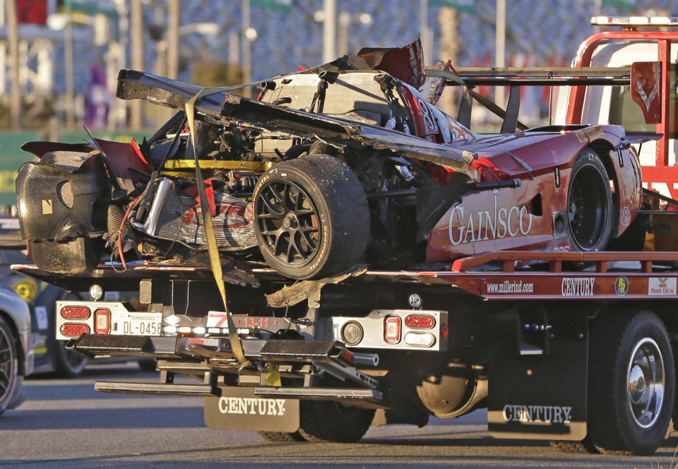 The GAINSCO Corvette DP is hauled away on a wrecker after driver Memo Gidley was involved in a crash during the IMSA Series Rolex 24 hour auto race at Daytona International Speedway in Daytona Beach, Fla., Saturday, Jan. 25, 2014. (AP Photo/John Raoux)