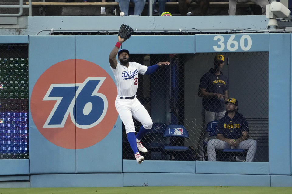 Los Angeles Dodgers right fielder Jason Heyward makes a catch on a ball hit by Milwaukee Brewers' Carlos Santana during the first inning of a baseball game Thursday, Aug. 17, 2023, in Los Angeles. (AP Photo/Mark J. Terrill)