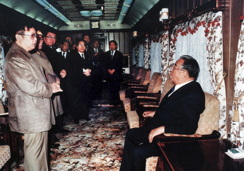 FILE - In this photo from North Korea's official Korean Central News Agency, distributed by Korea News Service, leader Kim Il Sung, right, and Kim Jong Il have a conversation in a special train before an unofficial visit to China, in November 1989. North Korea’s Kim Jong Un's train journey to Russia has a storified history. The tradition of train travel extends across the generations. That’s in evidence at the massive Kumsusan Palace of the Sun, where reconstructions of Kim Jong Un’s father’s and grandfather’s train cars, and the leaders’ preserved and displayed remains, are enshrined. (Korean Central News Agency/Korea News Service via AP Images, File)