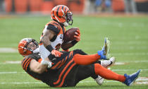 Cleveland Browns middle linebacker Joe Schobert, bottom, tackles Cincinnati Bengals running back Giovani Bernard during the first half of an NFL football game, Sunday, Dec. 8, 2019, in Cleveland. (AP Photo/David Richard)