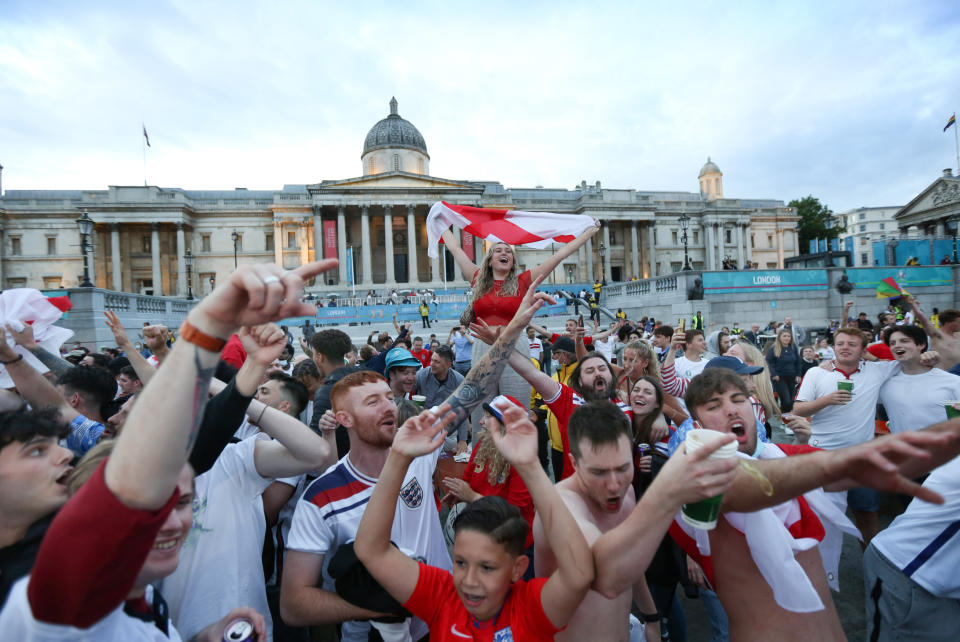 Covid-19 regulations are forgotten as England fans stand on their tables to celebrate as they watch the euro 2020 quarter final match between England and Ukraine from inside the Fan Zone set up to adhere to Covid-19 regulations in Trafalgar Square.